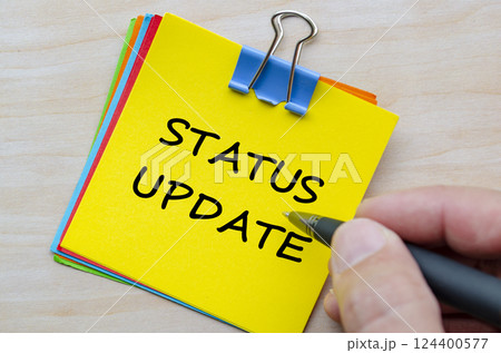Status Update text on yellow notepad. Business Updates and status concept 124400577