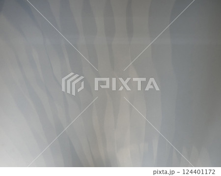 Shadows from sunlight shine on the floor in patterns 124401172