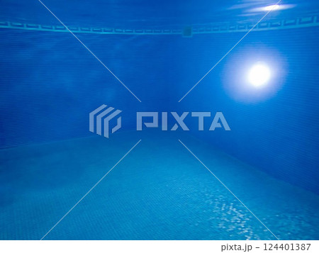 Underwater view of blue mosaic swimming pool interior light skimmer copy space 124401387