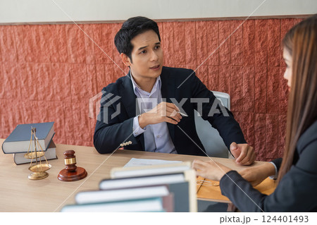 Legal Consultation and Law Practice. A lawyer providing legal advice to a client in a professional office setting. Legal Consultation and Law Practice. A lawyer providing legal advice to a client in a professional office setting. 124401493