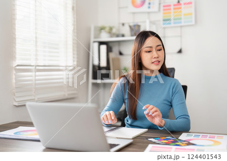Design Planning and Inspiration. A woman reviewing color swatches and engaging in creative design decisions. Design Planning and Inspiration. A woman reviewing color swatches and engaging in creative design decisions. 124401543