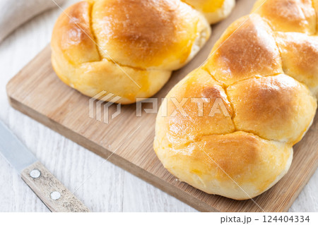 Traditional Easter braided bread. Tsoureki braid on wooden table Traditional Easter braided bread. Tsoureki braid on wooden table 124404334
