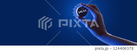 Person adjusting glowing dial labeled SALES against dark background in neon, optimization of sales performance. 124406378
