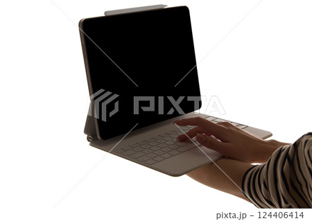 Woman typing detachable keyboard connected to tablet with dark blank screen isolated on white background. Mockup Woman typing detachable keyboard connected to tablet with dark blank screen isolated on white background. Mockup 124406414
