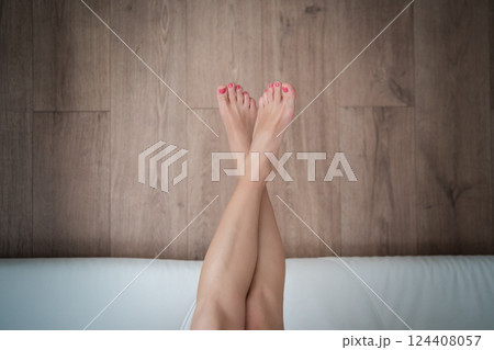Close-up of a young woman's legs on the bed. 124408057