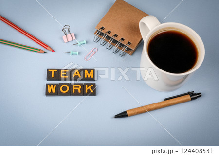 Teamwork concept. Text from old alphabet letters. Coffee mug on the table 124408531