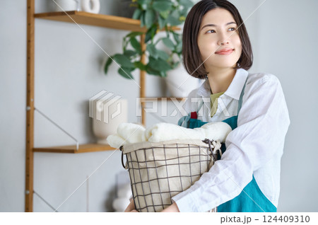 洗濯かごを抱えた若い女性 洗濯かごを抱えた若い女性 124409310