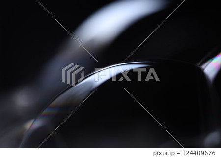 Bright liquid line on black background, phenomenal rainbow reflection, beautiful physical effects 124409676