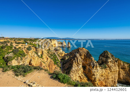 Ponta da Piedade is a unique rock formation with famous grottos in the ocean at Lagos, Algrave, Portugal 124412601