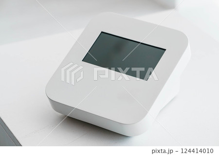 Modern Minimalistic White Digital Device with Blank Screen on Neutral Surface Modern Minimalistic White Digital Device with Blank Screen on Neutral Surface 124414010
