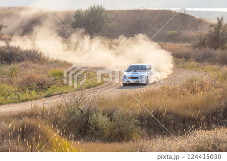 White Car on a Turn and a Cloud of Dust 124415030