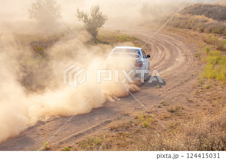 White Car Drives away in a Cloud of Dust 124415031