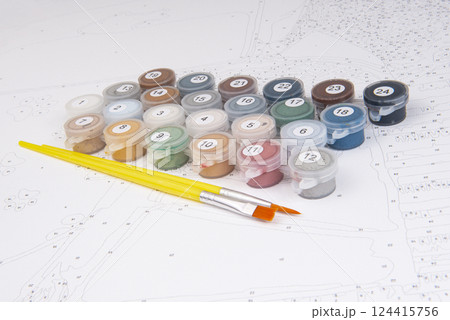 A set of colorful gouache paints, brushes and canvas with numbers is ready for drawing education. Hobby and leisure activity. Background with copy space 124415756