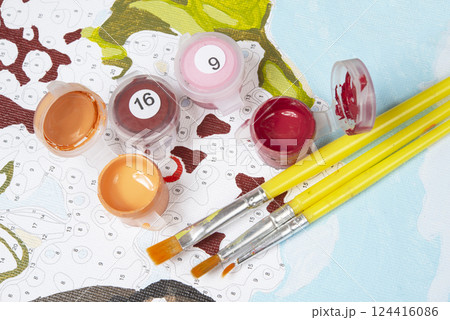 Painting by numbers. Set to paint the picture, includes a canvas, paints of different colors, brushes. Top view. Painting by numbers. Set to paint the picture, includes a canvas, paints of different colors, brushes. Top view. 124416086