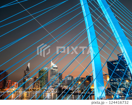 modern cable-stayed suspension bridge over Saigon river with illumination lights, financial downtown district on background, Ho Chi Minh city, Vietnam aerial drone view modern cable-stayed suspension bridge over Saigon river with illumination lights, financial downtown district on background, Ho Chi Minh city, Vietnam aerial drone view 124416732