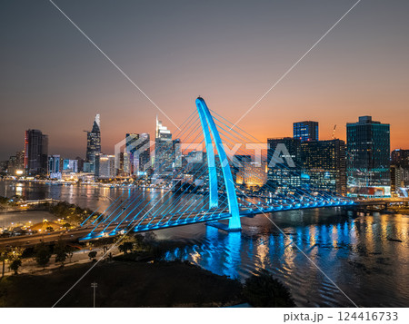 modern cable-stayed suspension bridge over Saigon river with illumination lights, financial downtown district on background, Ho Chi Minh city, Vietnam aerial drone view modern cable-stayed suspension bridge over Saigon river with illumination lights, financial downtown district on background, Ho Chi Minh city, Vietnam aerial drone view 124416733