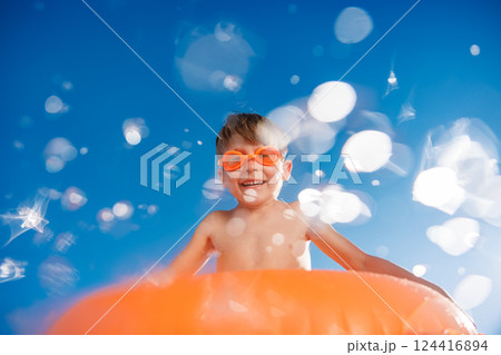 Happy child playing in waterpark. Kid having fun on summer vacation Happy child playing in waterpark. Kid having fun on summer vacation 124416894