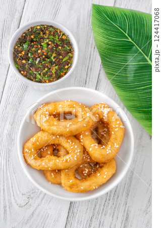 Crispy battered calamari rings with sesame seeds and spicy Asian dipping sauce Crispy battered calamari rings with sesame seeds and spicy Asian dipping sauce 124417068