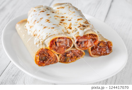 Oven-Baked Cannelloni Stuffed with Savory Bolognese and Covered in Golden Mozzarella 124417070