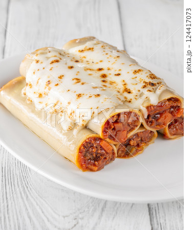 Oven-Baked Cannelloni Stuffed with Savory Bolognese and Covered in Golden Mozzarella 124417073