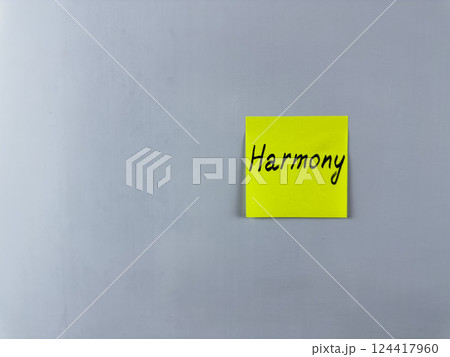 Sticky note with the word Harmony written on it, placed on white background. Ideal for illustrating harmony, balance, and unity in life and relationships. Perfect for concept creation 124417960