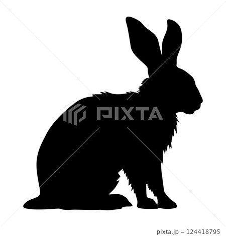 Silhouette of a sitting rabbit with long ears and fluffy fur against a plain background during early evening light 124418795