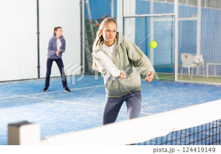 Girl tennis player playing padel tennis 124419149