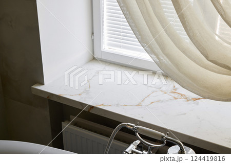 An Elegant Bathroom Window with a Marble Sill and Soft Drapery, enhancing relaxation An Elegant Bathroom Window with a Marble Sill and Soft Drapery, enhancing relaxation 124419816
