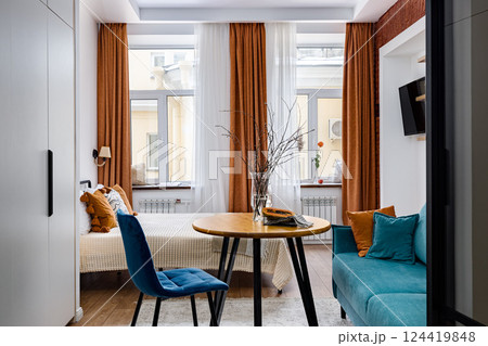 An Elegant and Stylish Modern Room Featuring Cozy Furniture Along with Bright Windows An Elegant and Stylish Modern Room Featuring Cozy Furniture Along with Bright Windows 124419848