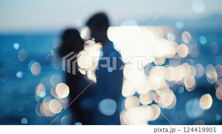 Blurry images of a couple saying I do with the ocean in the background at their beach nuptials 124419901