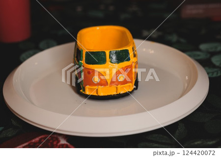 A Vibrant and Colorful Miniature VW Bus Displayed on a Decorative Plate for Aesthetic Appeal A Vibrant and Colorful Miniature VW Bus Displayed on a Decorative Plate for Aesthetic Appeal 124420072