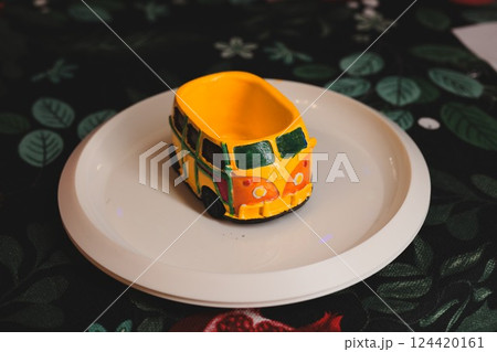 A Beautiful and Colorful Vintage Car Bowl, Artfully Presented on a Stylish Decorative Plate A Beautiful and Colorful Vintage Car Bowl, Artfully Presented on a Stylish Decorative Plate 124420161