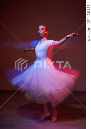 Caucasian woman dancing classical dance in tutu . Long exposure photo. Caucasian woman dancing classical dance in tutu . Long exposure photo. 124420188