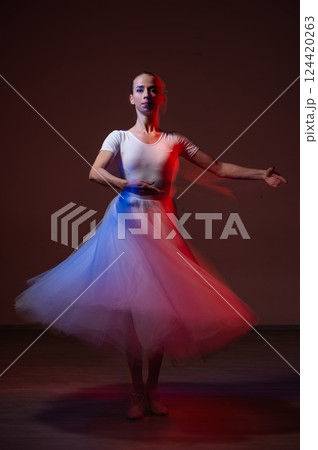 Caucasian woman dancing classical dance in tutu . Long exposure photo. Caucasian woman dancing classical dance in tutu . Long exposure photo. 124420263