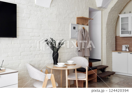 A Modern Minimalist Kitchen and Dining Area that features Cozy Decor and Elegant Touches 124420394