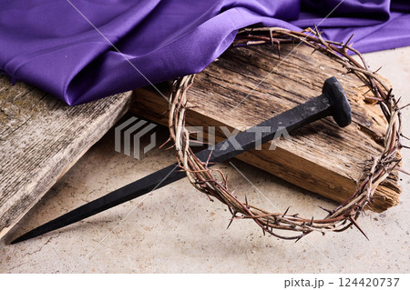 Easter background depicting the crucifixion with a rustic wooden cross, crown of thorns and nails. Easter background depicting the crucifixion with a rustic wooden cross, crown of thorns and nails. 124420737