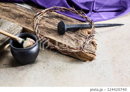 Easter background depicting the crucifixion with a rustic wooden cross, crown of thorns and nails. Easter background depicting the crucifixion with a rustic wooden cross, crown of thorns and nails. 124420740