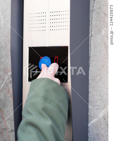 Person entering security code on keypad access control system. Person entering security code on keypad access control system. 124420873