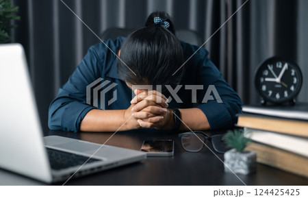 Businesswoman praying at work. Contemplative prayer thinking in office. Hands folded in prayer gesture beg about something. woman with hands clasped praying while sitting at desk in office. Businesswoman praying at work. Contemplative prayer thinking in office. Hands folded in prayer gesture beg about something. woman with hands clasped praying while sitting at desk in office. 124425425