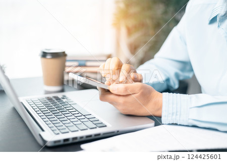 Business woman working on documents looking concentrated with briefcase on table. Businesswoman is deeply reviewing a financial report for a return on investment or investment risk analysis. 124425601