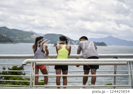 young asian people relaxing by the sea 124425654