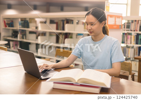 Young student eagerly enters the classroom, ready to immerse themselves in world of learning and education at college, studying books alongside their peers in university. 124425740