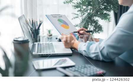 Business woman entrepreneur in office using laptop at work, professional middle aged female company executive working on computer at workplace. Female entrepreneur working in home office at her desk. 124426302