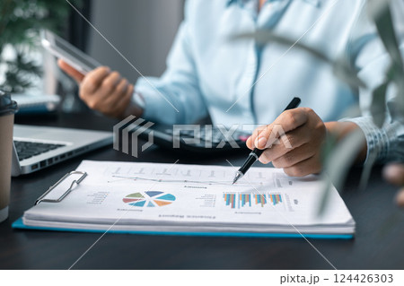 Business woman entrepreneur in office using laptop at work, professional middle aged female company executive working on computer at workplace. Female entrepreneur working in home office at her desk. Business woman entrepreneur in office using laptop at work, professional middle aged female company executive working on computer at workplace. Female entrepreneur working in home office at her desk. 124426303