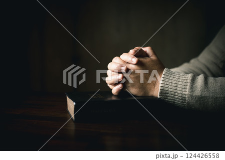 Man hand in prayer, expressing his religious faith in God through worship of Jesus Christ. Person man, turned to God in prayer, demonstrating their religious faith and devotion through worship. Man hand in prayer, expressing his religious faith in God through worship of Jesus Christ. Person man, turned to God in prayer, demonstrating their religious faith and devotion through worship. 124426558