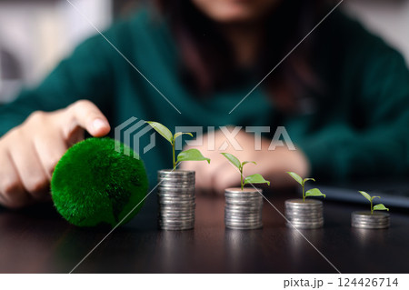 Concept of financial growth involves wisely investing money to save, accumulate wealth, metaphorically nurturing it like tree, coin representing business opportunity. Finance, investment, environment Concept of financial growth involves wisely investing money to save, accumulate wealth, metaphorically nurturing it like tree, coin representing business opportunity. Finance, investment, environment 124426714