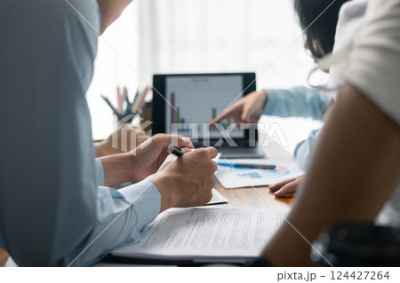 Financial analyst presented a detailed data analysis graph to their colleague, corporate office, demonstrating the business's financial status and trends. Concept of business data analysis. 124427264