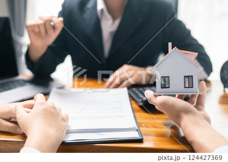Real estate agent facilitated sale of property through mortgage loan, ensuring smooth investment process for purchaser with help of skilled broker. Concept of loan, insurance, approval, real estate. 124427369