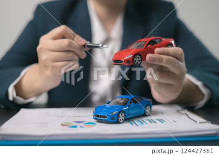 Agent facilitated a business deal, finalizing the agreement for automobile insurance to protect the vehicle during transport. car insurance concept. Agent facilitated a business deal, finalizing the agreement for automobile insurance to protect the vehicle during transport. car insurance concept. 124427381
