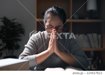 Christian woman spent her evenings reading and studying Bible, deepening her faith and understanding of her religion while taking moments to pray and reflect on what she was learning. bible, book. Christian woman spent her evenings reading and studying Bible, deepening her faith and understanding of her religion while taking moments to pray and reflect on what she was learning. bible, book. 124427621